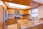 The kitchen features beautiful recessed ceiling and lighting, and ocean views from the sink
